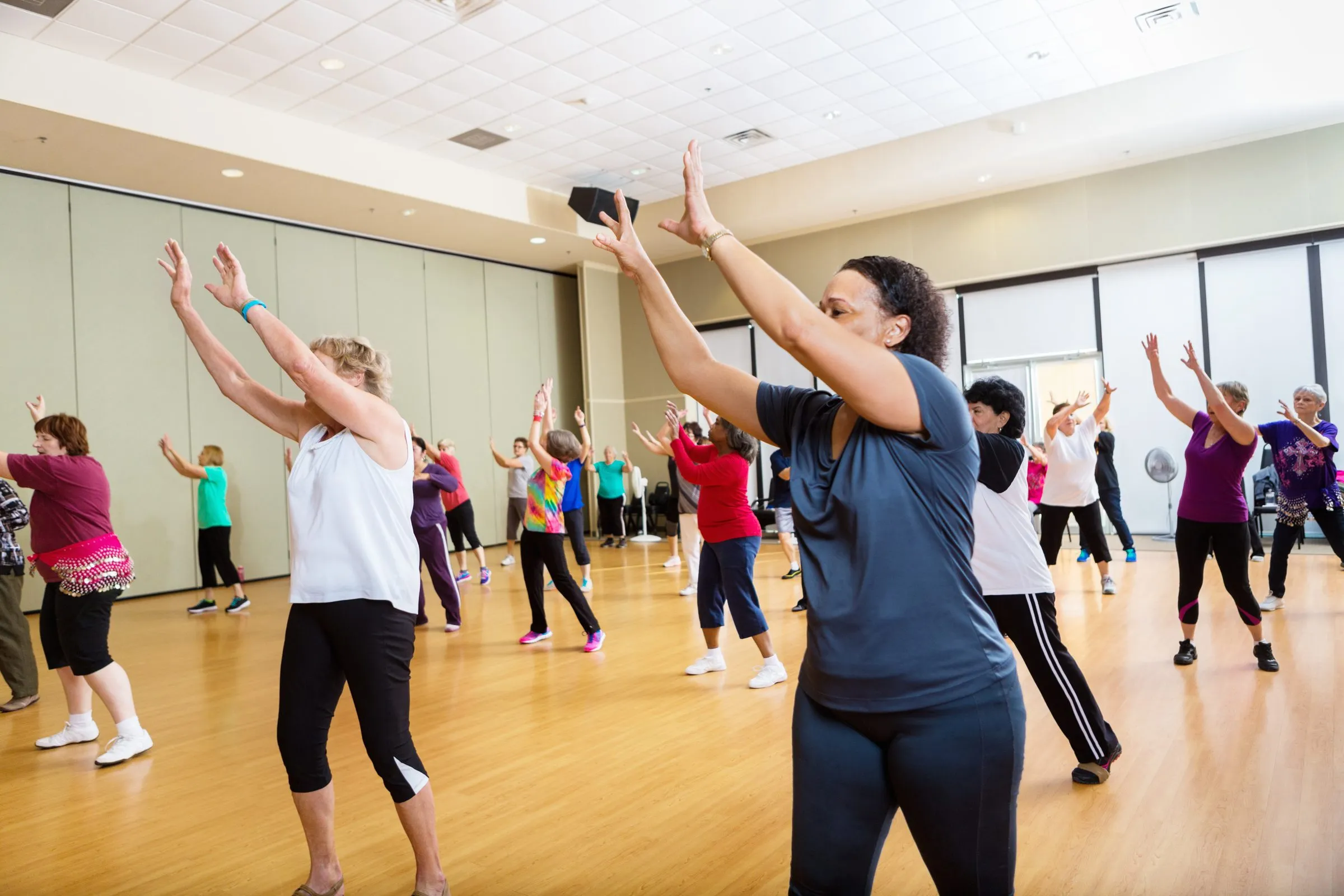 People exercise together in a community hall