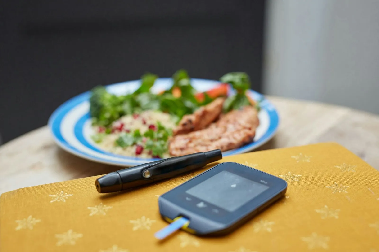 A balanced meal beside a blood glucose meter