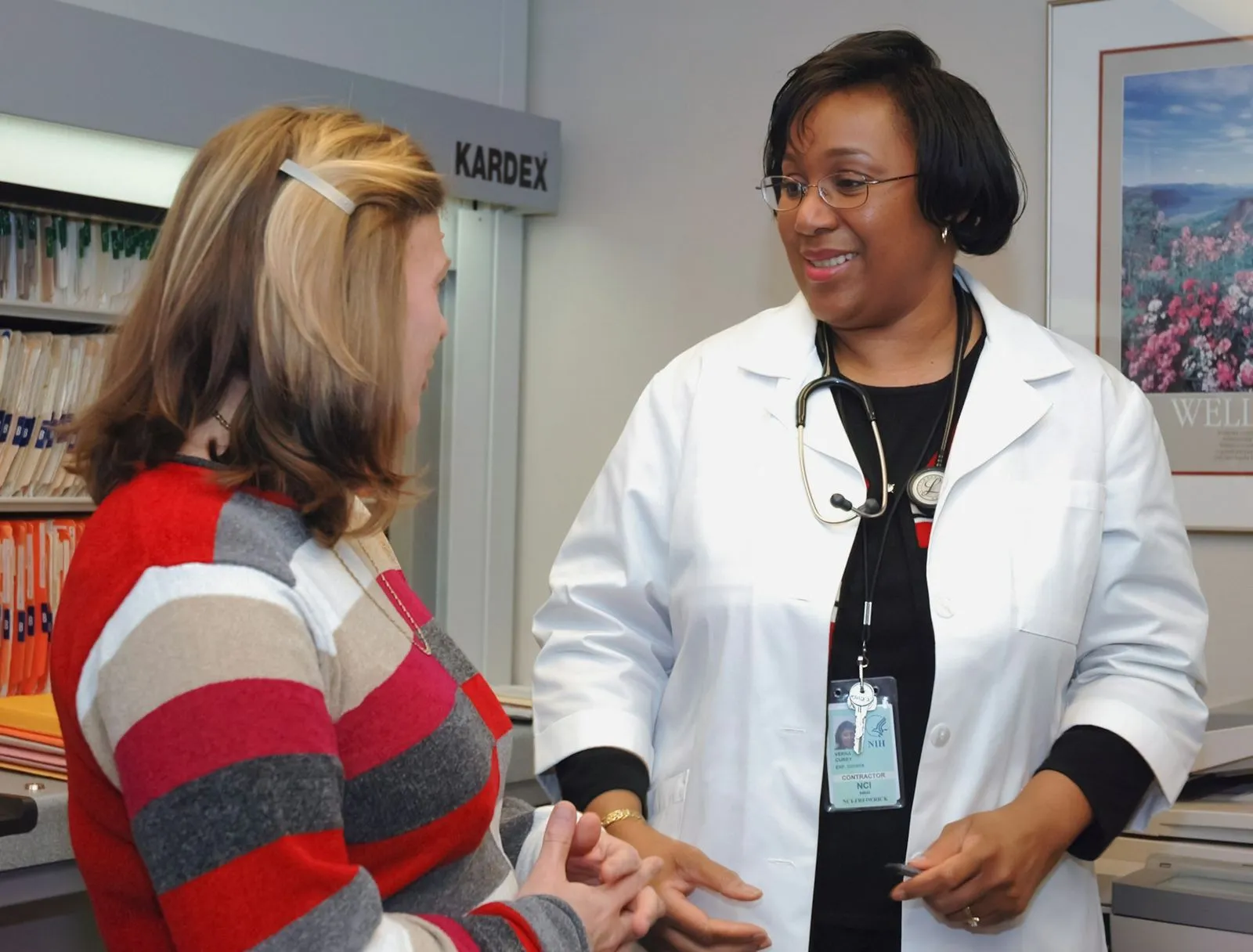 A clinician talks with a patient in a GP surgery