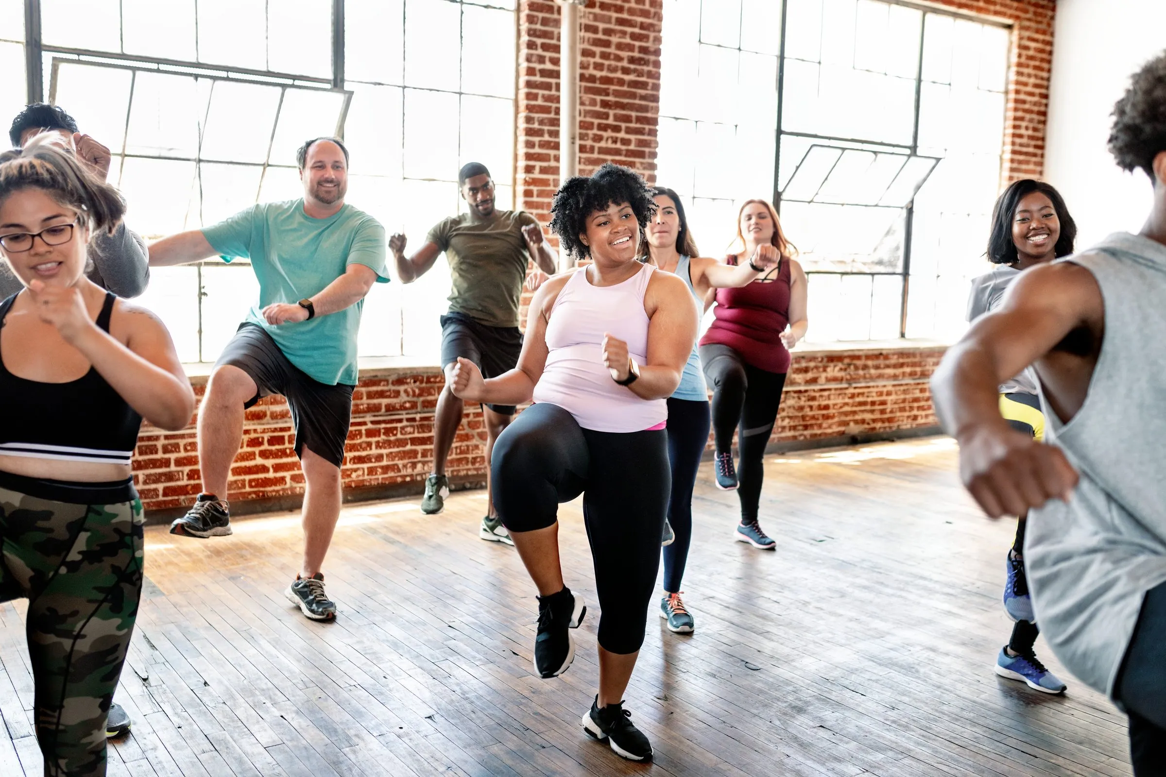 People take part in an exercise class in a studio