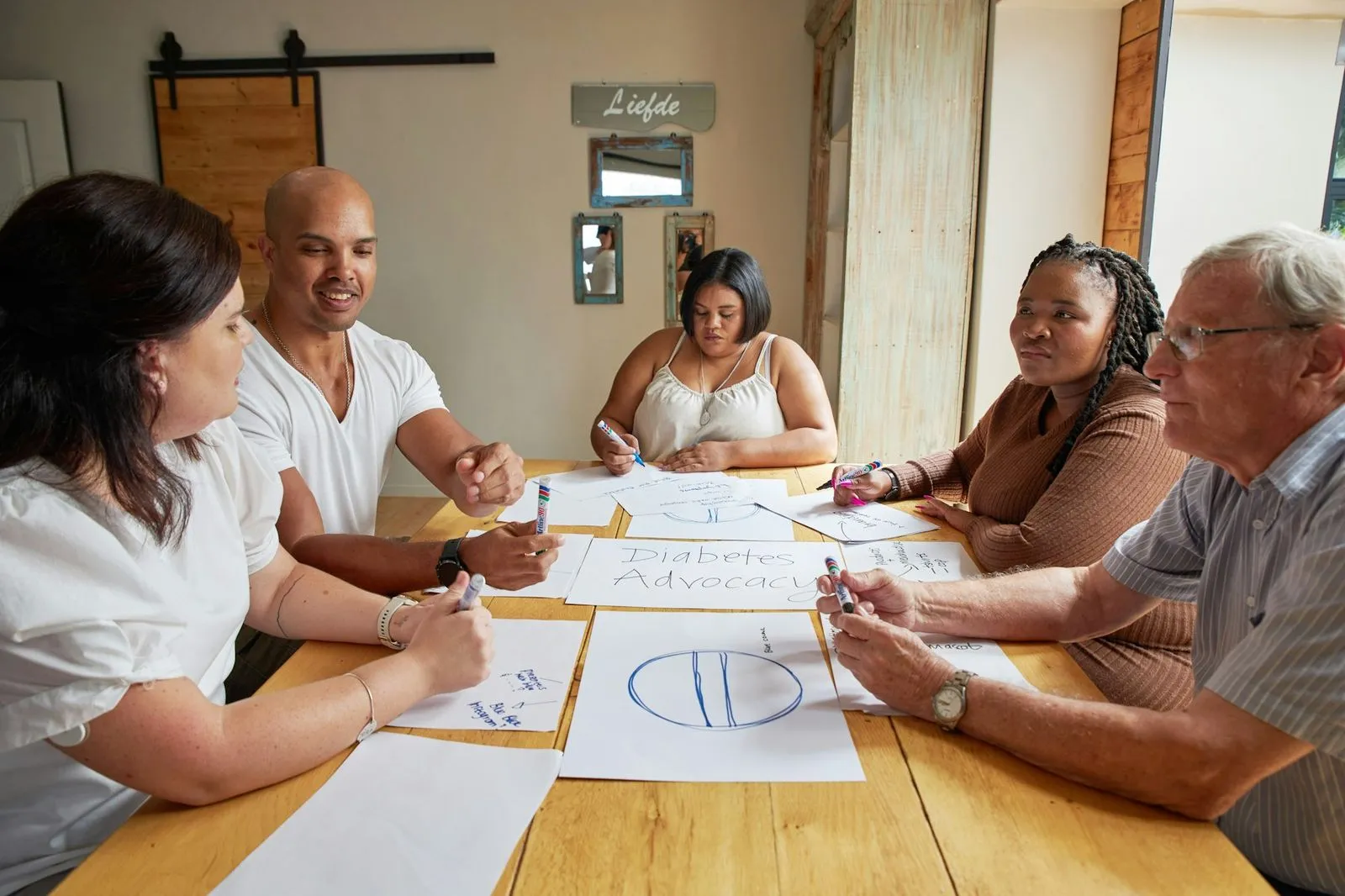 A multidisciplinary team reviews plans around a table