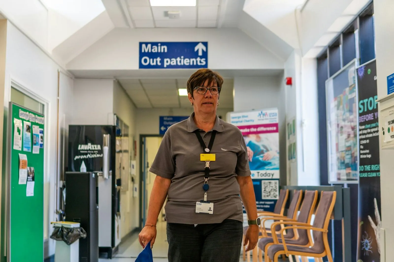 A member of staff walks through a hospital outpatients department